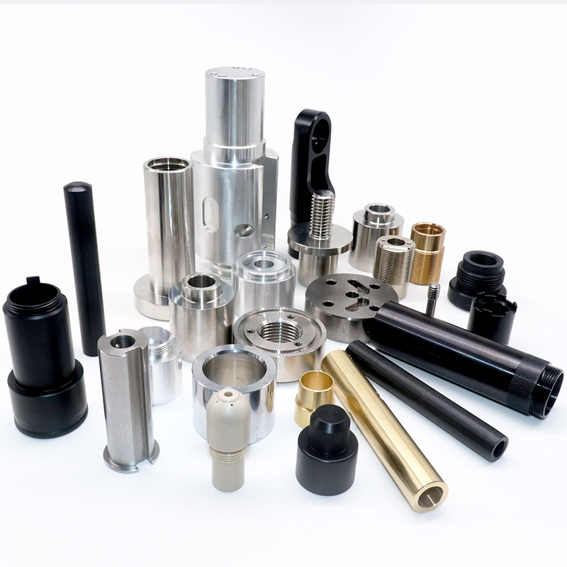 Various precision-machined metal parts, including cylinders, rods, and fittings