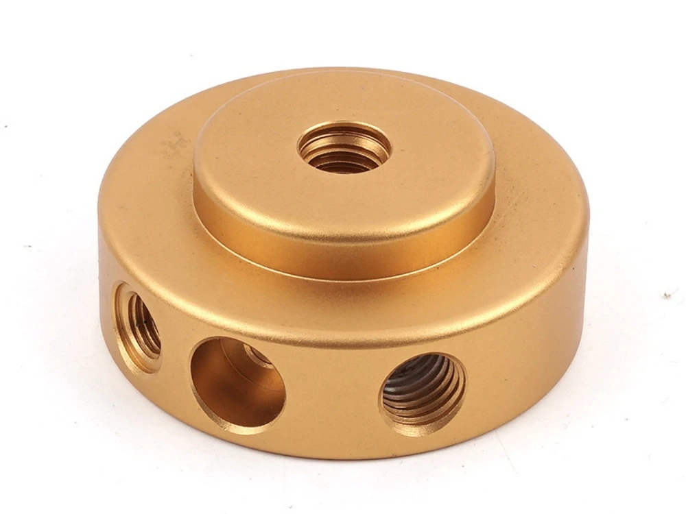 Gold plated CNC turned disc manifold block with multiple threaded ports