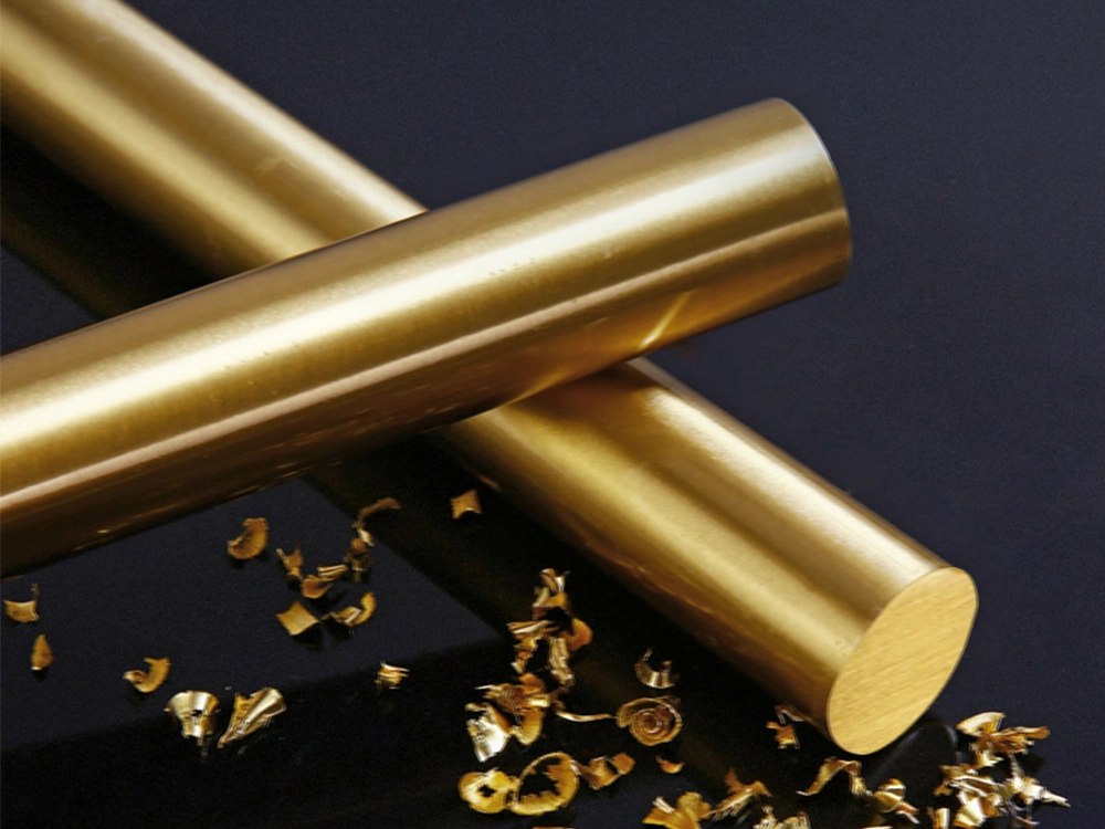 Raw brass round bar stock with machining chips, used as feedstock for CNC turned parts