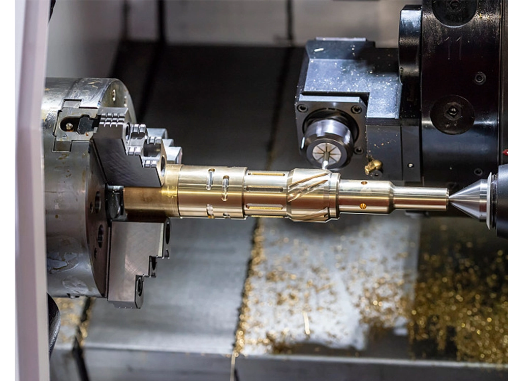 CNC lathe machining a copper-brass shaft component, showing precision turning with metal chips