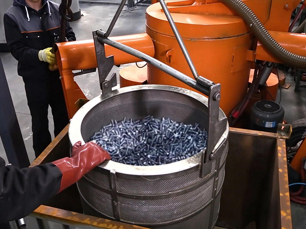 Precision fasteners in a basket during black oxide finishing